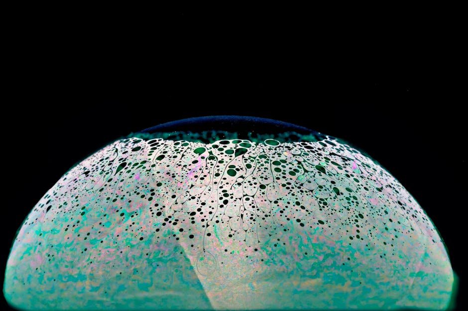 A captivating abstract image of a soap bubble resembling a surreal planet with cellular patterns.